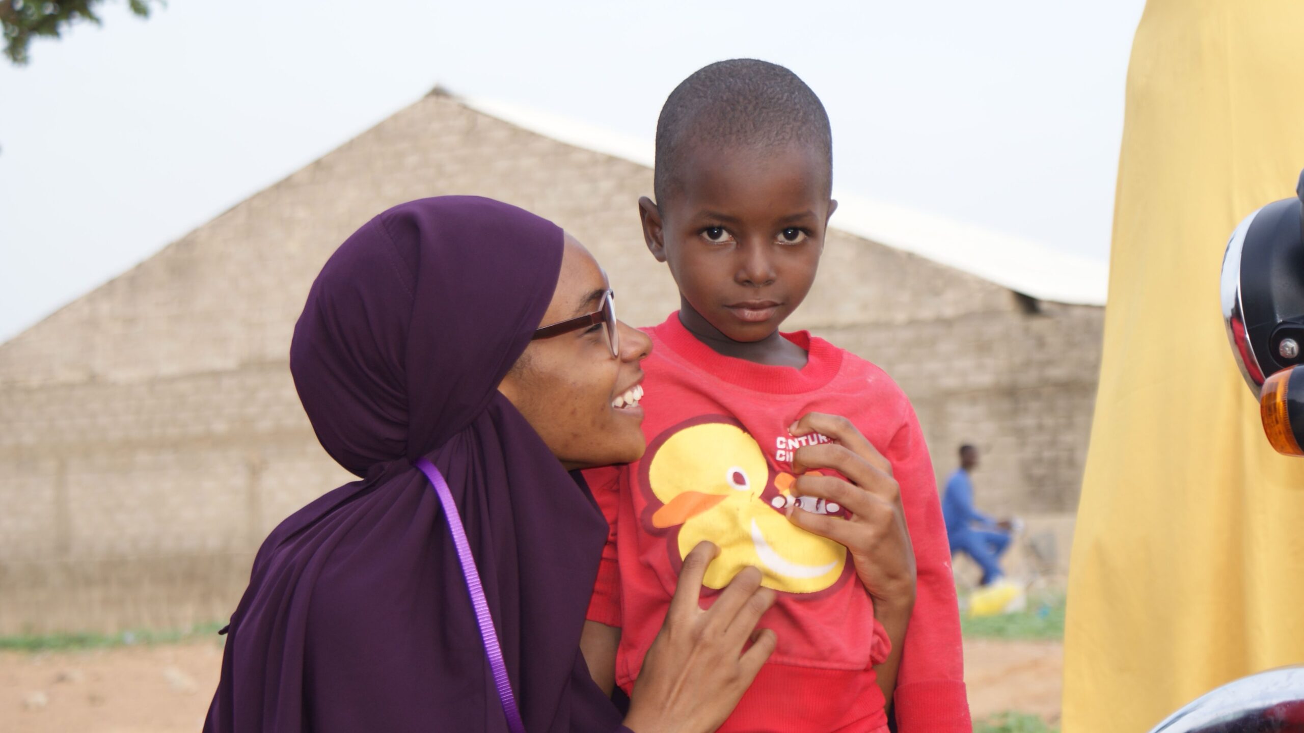 FLO Foundation CEO smiles at Nigerian during a community outreach project